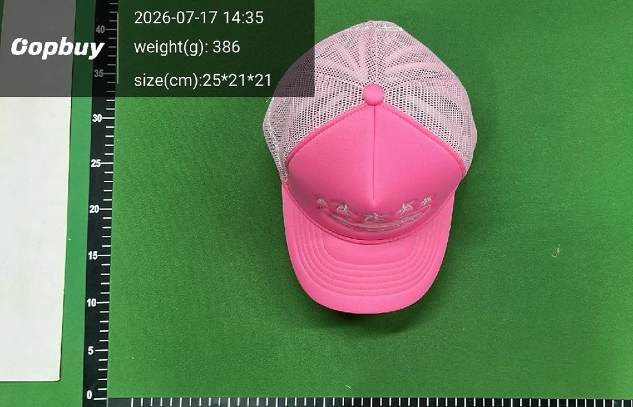 A pink cap photographed on the warehouse measuring mat